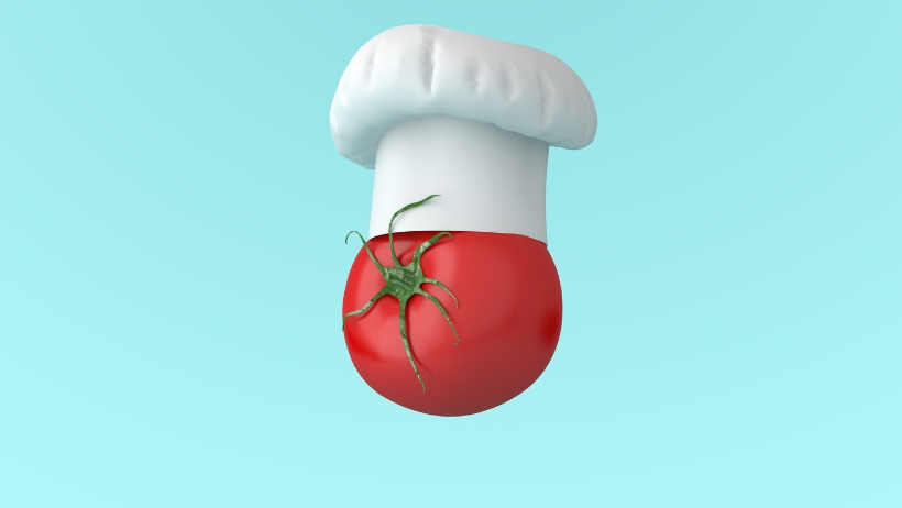 Eine rote Tomate mit weißer Kochmütze auf hellblauem Hintergrund symbolisiert vegane Ernährung und verdeutlicht die Vorteile für Gesundheit und Umwelt.